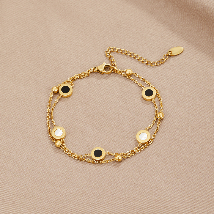 Carla – Pulsera suave con elementos redondos contrastantes.